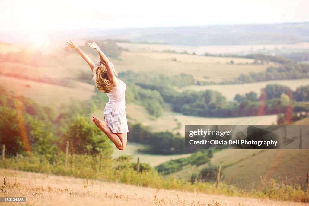 Girl Happily Jumping in Field