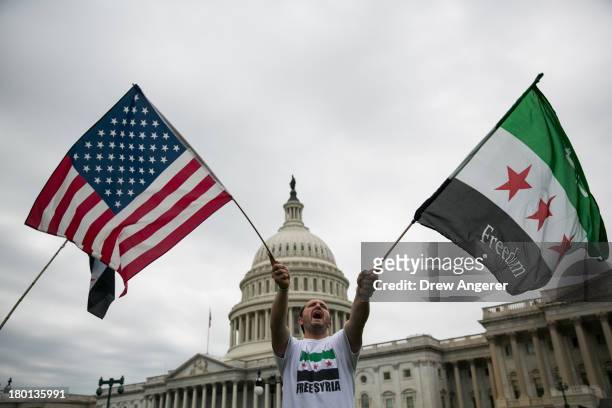 Jehad Sibai waves flags during a rally in support of possible U.S. Military action in Syria, on Capitol Hill, on September 9, 2013 in Washington, DC....