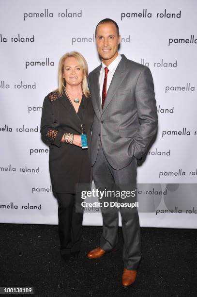 Pamella Roland and Nigel Barker pose backstage at the pamella roland Spring 2014 fashion show during Mercedes-Benz Fashion Week on September 9, 2013...