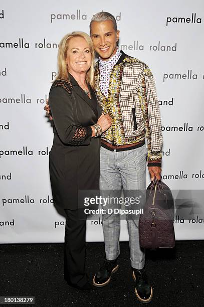 Jay Manuel and designer Pamella Roland pose backstage at the pamella roland Spring 2014 fashion show during Mercedes-Benz Fashion Week on September...