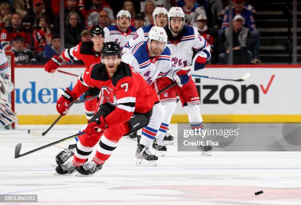 Blake Wheeler of the New York Rangers scores an empty net goal as Dougie Hamilton of the New Jersey Devils reacts during the third period at...