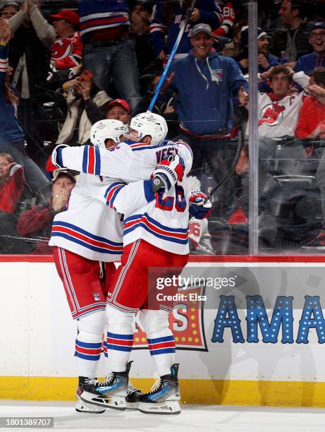 Jimmy Vesey of the New York Rangers is congratulated by K'Andre Miller after Vesey scored a goal during the third period against the New Jersey...