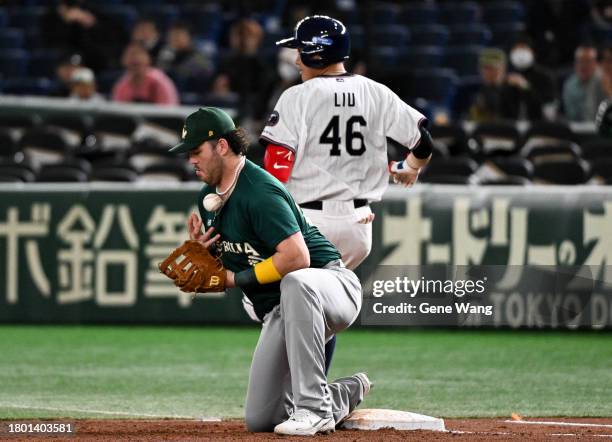 Infielder Ji Hong Liu of Chinese Taipei hits and cause an error in the bottom of the third inning during the Asia Professional Baseball Championship...