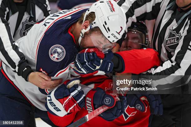 Oshie of the Washington Capitals and Sean Kuraly of the Columbus Blue Jackets grapple and punch during the second period at Capital One Arena on...