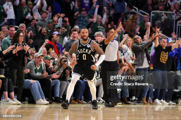 Damian Lillard of the Milwaukee Bucks reacts to a three point shot against the Dallas Mavericks during the second half of a game at Fiserv Forum on...