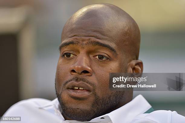 Coach Tra Thomas of the Philadelphia Eagles sits on the sideline before the game against the New York Jets at MetLife Stadium on August 29, 2013 in...