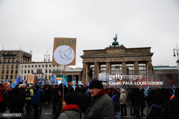 Supporters of former Linke politician Sahra Wagenknecht take part in a demonstration against war and arming in Berlin at the Brandenburg Gate on...