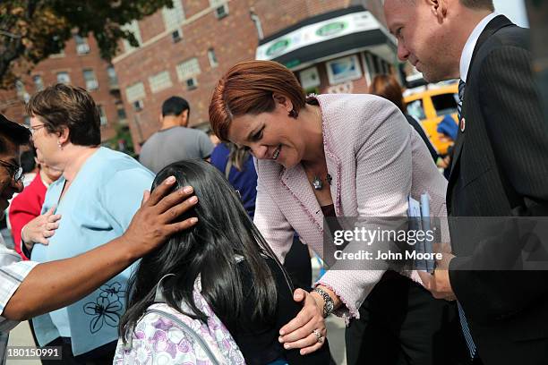 New York City mayoral candidate Christine Quinn talks with children outside a school on September 9, 2013 in the Queens borough of New York City....