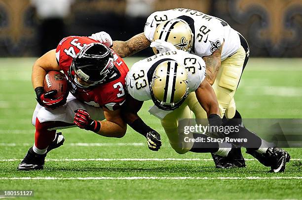 Bradie Ewing of the Atlanta Falcons is brought down Jabari Greer of the New Orleans Saints during a game at the Mercedes-Benz Superdome on September...