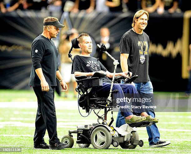 Sean Payton, head coach of the New Orleans Saints, takes the field with former players Steve Gleason and Scott Fujita prior to a game against the...