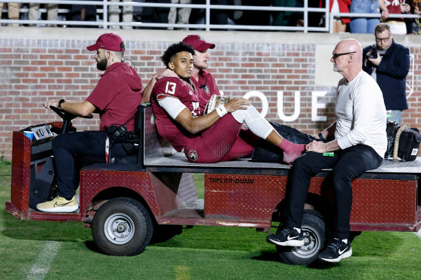 Quarterback Jordan Travis of the Florida State Seminoles is carted off the field after an ankle jury during the game against the North Alabama Lions...