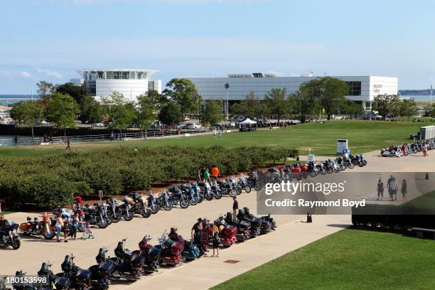 Hundreds of Harley-Davidson motorcycles from around the world, line up outside the Milwaukee Art Museum with Discovery World in the background to...