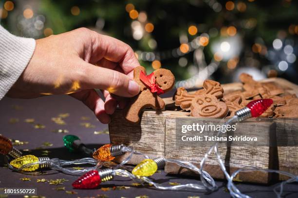 christmas gingerbread cookies and lights - biscuit tin stock pictures, royalty-free photos & images