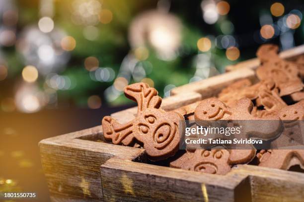 christmas gingerbread cookies closeup and defocused lights - biscuit tin stock pictures, royalty-free photos & images
