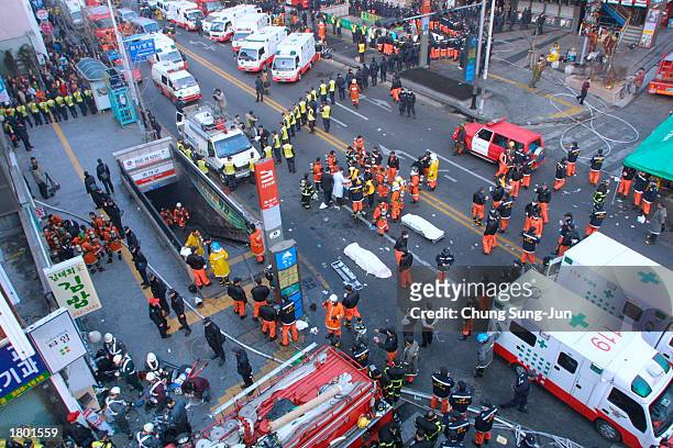 South Korean rescue team workers and firefighters surround a subway station February 18, 2003 in Daegu, 200 miles southeast of Seoul, South Korea....