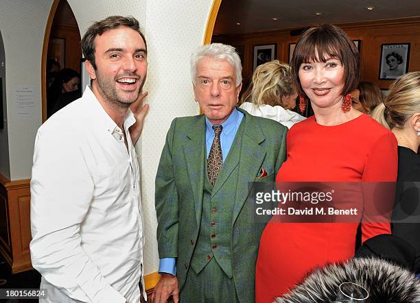 Guest, Nicky Haslam and Carol Victor attend the Tatler Bystander exhibition, featuring the 50 best party pictures of the past 50 years, at Annabels...