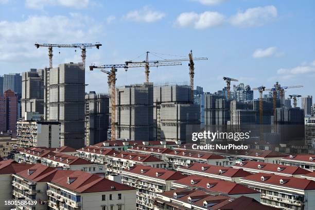 Several high-rise residential buildings are under construction in Shanghai, China, on November 25, 2023.