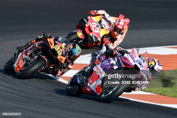 Ducati Spanish rider Jorge Martin rides ahead of KTM South African rider Brad Binder and Honda Spanish rider Marc Marquez during the sprint race of...