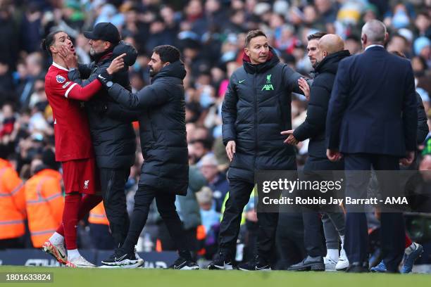 Jurgen Klopp the head coach / manager of Liverpool calms down Darwin Nunez as he reacts towards Pep Guardiola the head coach / manager of Manchester...