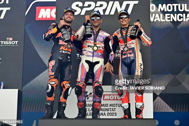South African rider Brad Binder , Ducati Spanish rider Jorge Martin and Honda Spanish rider Marc Marquez celebrate on the podium after the sprint...