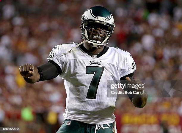 Quarterback Michael Vick of the Philadelphia Eagles celebrates after scoring on a three-yard touchdown run in the second quarter against the...