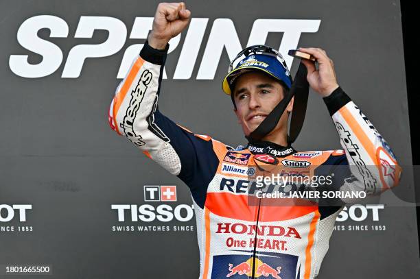 Third placed Honda Spanish rider Marc Marquez celebrates on the podium after the sprint race of the MotoGP Valencia Grand Prix at the Ricardo Tormo...