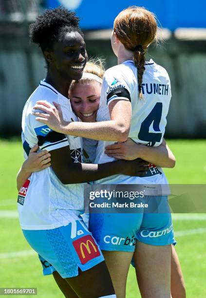 Fiona Worts of Sydney FC celebrates after scoring her teams first goal with Princess Ibini-Sei and Tori Tumeth of Sydney FC during the A-League Women...