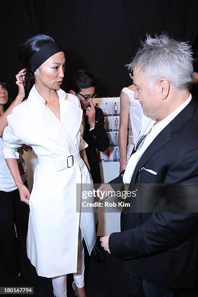 Designer Ken Kaufman works with a model backstage at the Kaufmanfranco show during Spring 2014 Mercedes-Benz Fashion Week at The Theatre at Lincoln...