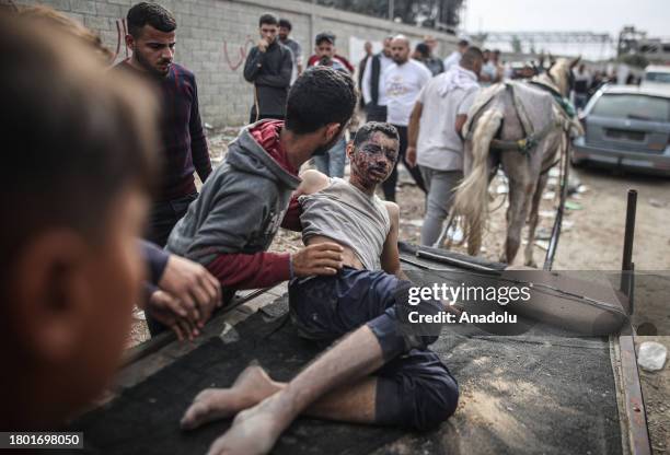 Palestinians transfer their relatives, who had been injured in the Israeli attacks on Gaza and were receiving treatment in hospitals located in the...