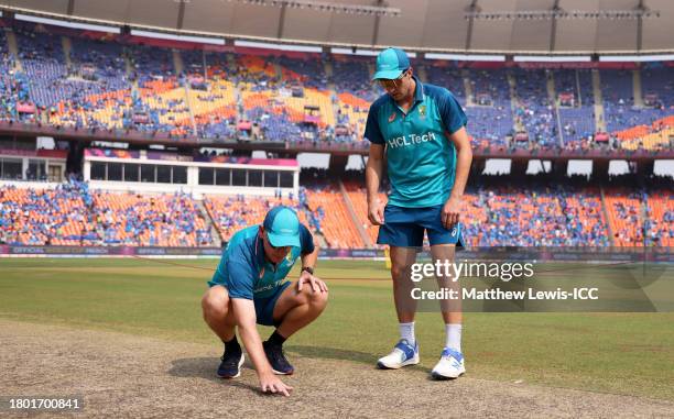 Pat Cummins of Australia and Andrew McDonald, Head Coach of Australia inspect the pitch ahead of the ICC Men's Cricket World Cup India 2023 Final...