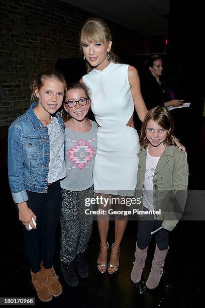 Musician Taylor Swift poses with fans at the "One Chance" Premiere during the 2013 Toronto International Film Festival at Winter Garden Theatre on...