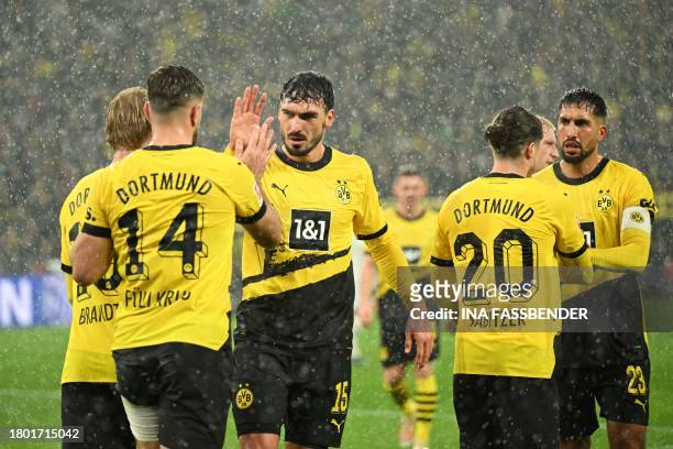 Dortmund's German forward Niclas Fuellkrug celebrates scoring the 2-2 goal with Dortmund's German defender Mats Hummels and team mates during the...
