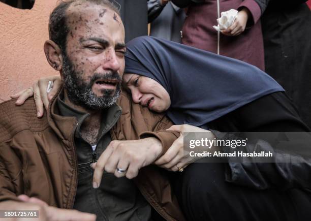 People mourn as they collect the bodies of Palestinians killed in airstrikes on November 19, 2023 in Khan Yunis, Gaza. Heavy fighting rages in the...