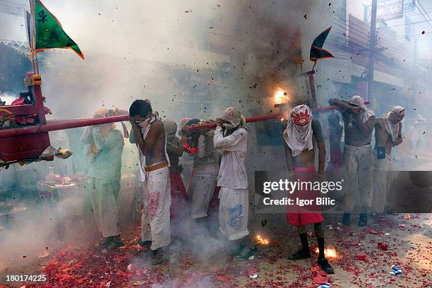 During the Vegetarian festivals street procession in Phuket, Thailand, firecrackers are used in large quantities. Somethimes they more look like bomb...