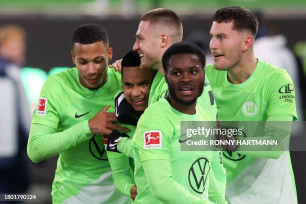 Wolfsburg's Brazilian defender Rogerio celebrates scoring the 2-1 goal with Wolfsburg's Danish forward Jonas Wind , Wolfsburg's German midfielder...