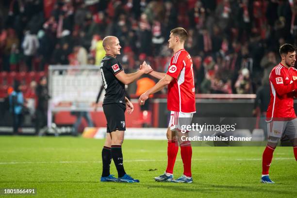 Ex-Union Berlin Player Sven Michel of FC Augsburg and Kevin Behrens of 1 FC Union Berlin after the game between dem 1 FC Union Berlin and FC Augsburg...