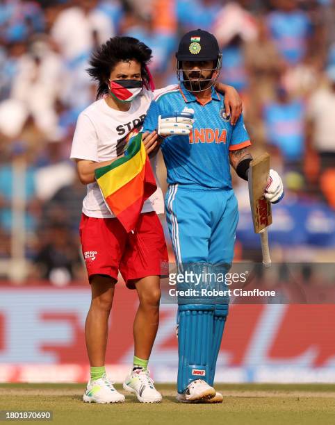 Pitch invader makes their way towards Virat Kohli of India during the ICC Men's Cricket World Cup India 2023 Final between India and Australia at...