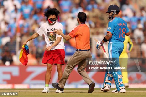 Pitch invader makes their way towards Virat Kohli of India during the ICC Men's Cricket World Cup India 2023 Final between India and Australia at...