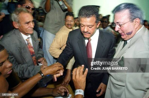 Leonel Fernandez of the Dominican Liberation Party is greeted by supporters after voting in Santo Domingo 16 May 2004. The Dominican Republic's...