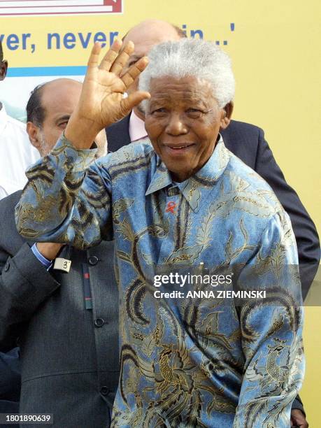 Former South African President Nelson Mandela waves during 'The Homecoming of the Elders' ceremony in District 6, Cape Town 11 February 2004,...
