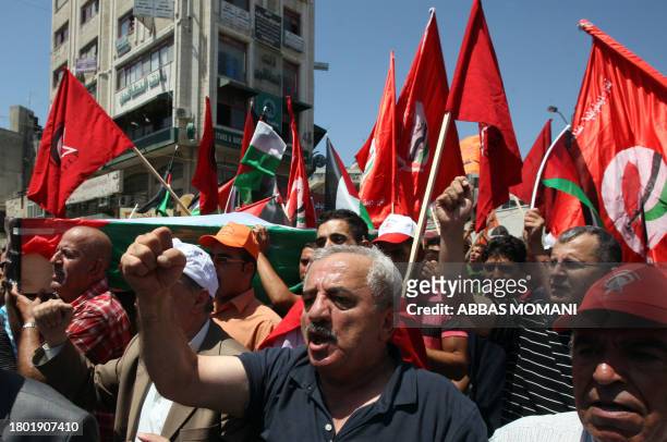 Palestinian supporters of the Democratic Front for the Liberation of Palestine carry the coffin of Mashhur Arouri, a party leader who was killed by...