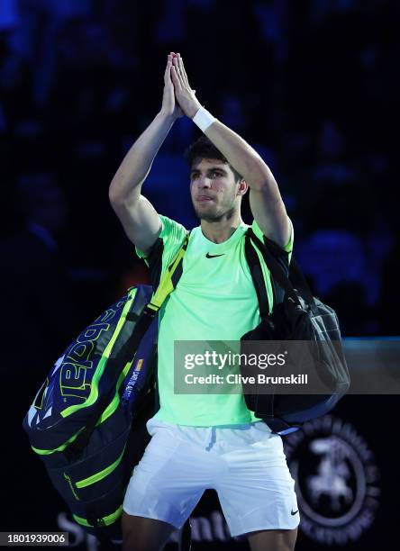 Carlos Alcaraz of Spain waves goodbye to the crowd as he walks off court after his straight sets defeat against Novak Djokovic of Serbia during the...