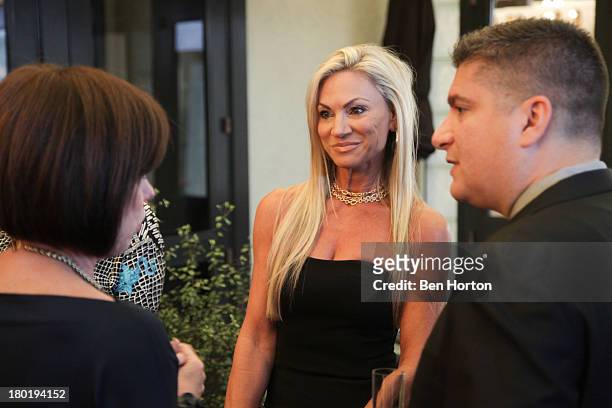 Deborah Gunn-Downing, Jennifer Condas and Sal Tramuto attend the Versace and the JDRF Dream Guild of Orange County pre-event dinner at Marche Moderne...