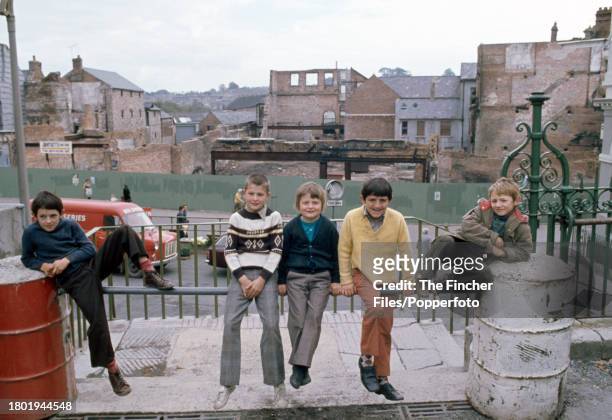 Young boys at play on the streets of bomb-damaged Armagh, Northern Ireland during The Troubles, circa 1975.