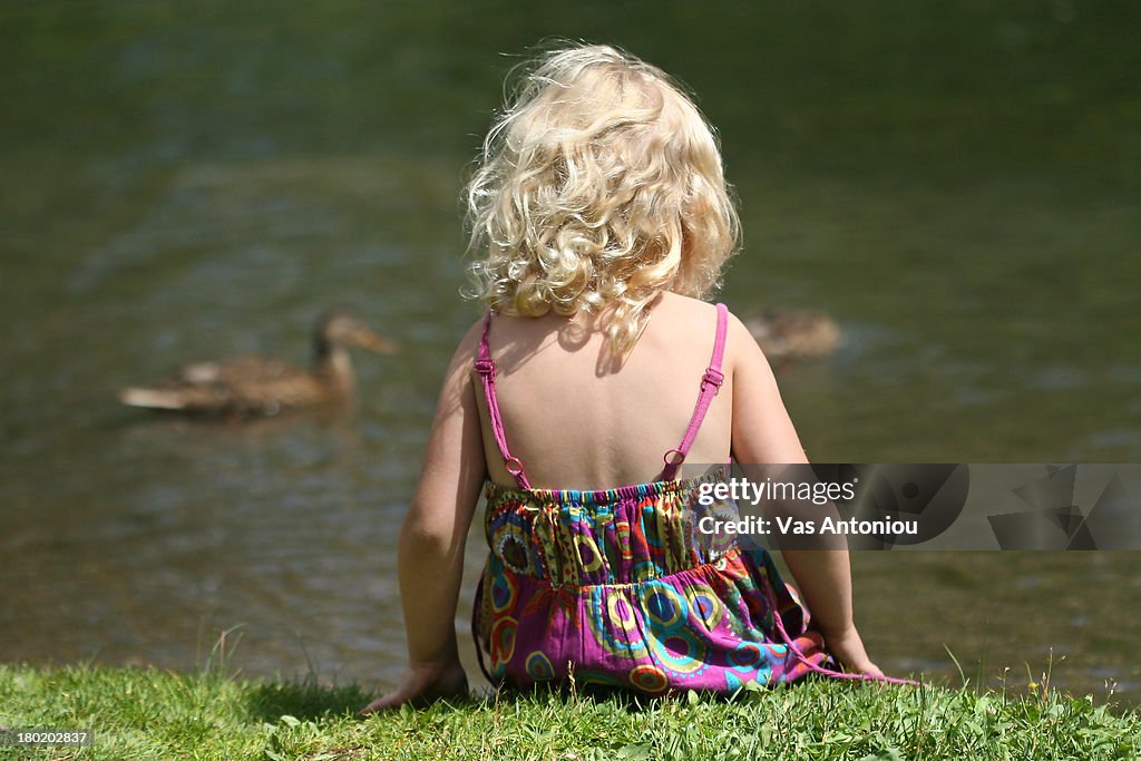Young girl in front of duck pond