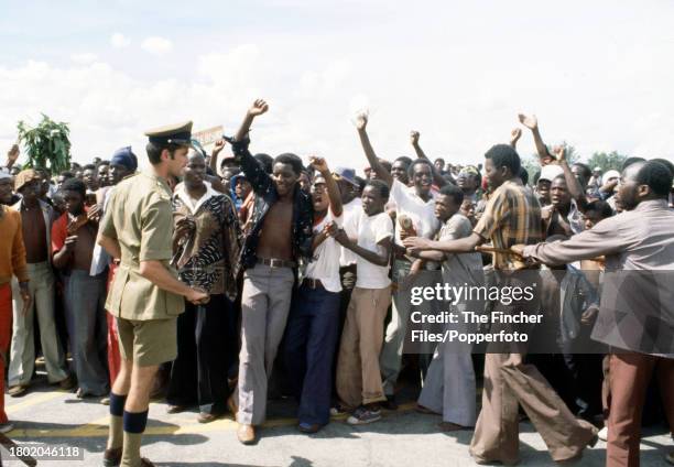 Exuberant supporters during the arrival of exiled leaders at Salisbury Airport for Rhodesian national elections, circa December 1979.