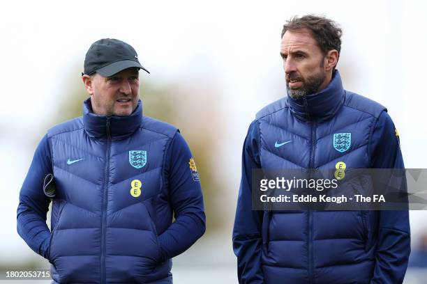 Gareth Southgate, Head Coach of England, speaks with Steve Holland, Assistant Coach of England, during an England Training Session at Tottenham...