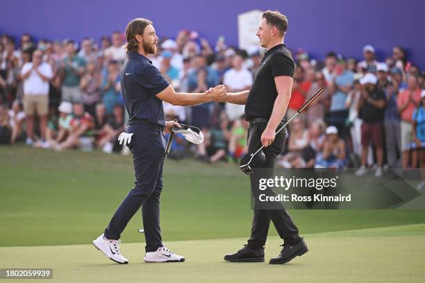 Tommy Fleetwood of England and Matt Wallace of England shake hands on the 18th green during Day Four of the DP World Tour Championship on the Earth...