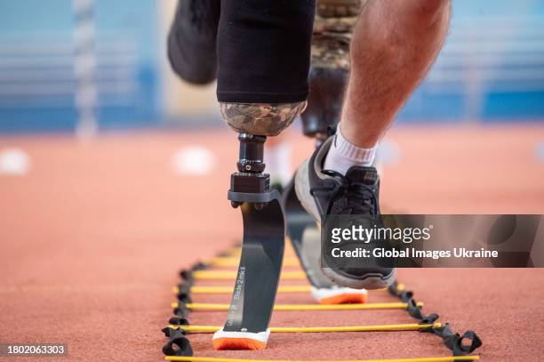 Patients with leg amputations perform running exercises on sports prostheses during a training session of Ukrainian military on November 18, 2023 in...