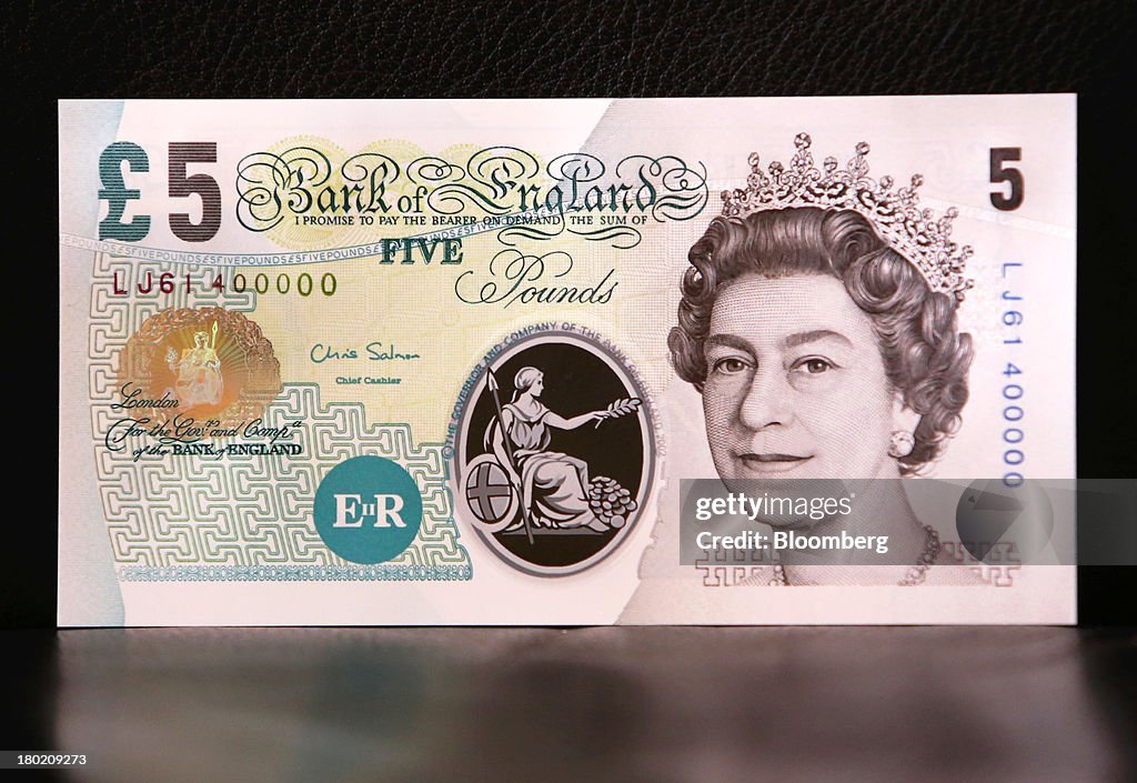£ 5 Note A sample Polymer five pound British banknote sits on display during a ...
